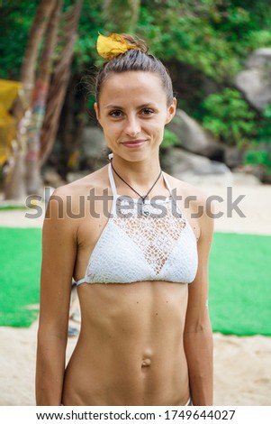 portrait of a beautiful girl in a white swimsuit in Thailand