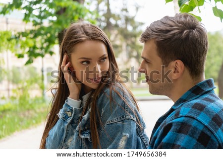 pretty girl touching hair while flirting with boyfriend Royalty-Free Stock Photo #1749656384