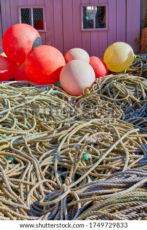 Image of old fishing ropes with float bouys in front of a timber fishing hut. Selective Focus, Jersey, Channel Islands, UK