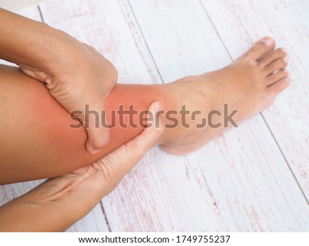 Women suffering with leg pain, ankle pain, inflammation and red swelling. Royalty-Free Stock Photo #1749755237