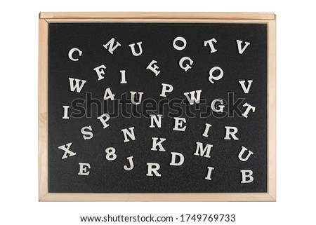 White numbers and letters of English alphabet on black magnetic board. Learning of letters and digits with kids.