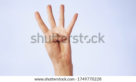 closeup male hand isolated on a white background four fingers raised up.