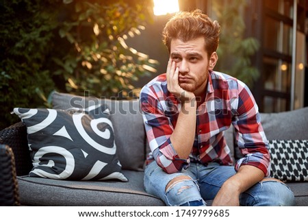 Man is bored alone outdoor