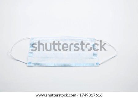 Three-layer protective mask for individual use on elastic bands with a nose clip
