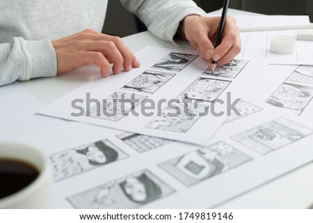 Artist illustrator draws a storyboard for the film. The animator creates sketches for the cartoon. Royalty-Free Stock Photo #1749819146