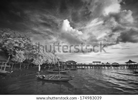 Boat docking at beach under cloudy sky. taken at Kenjeran beach, Surabaya, east Java, Indonesia
