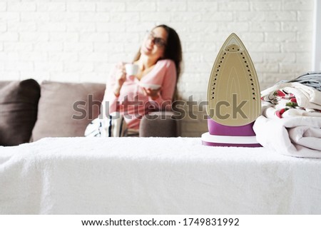   iron and linen against the background of a resting girl                             
