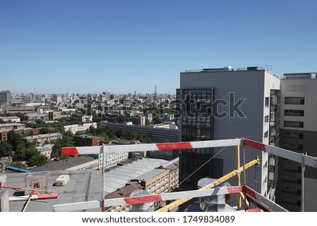 roof construction, iron reinforcement, crane against the sky horizon city view