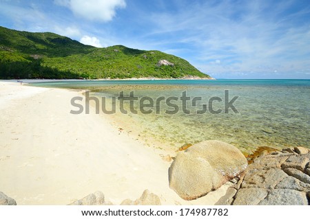 Gorgeous sandy beach with transparent water, coral reef and lush green rainforest at Ao Haad Khuad, Koh Phangan, Southern Thailand.