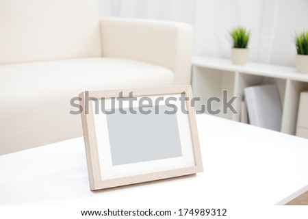 blank photo frame with copy space on white table at home