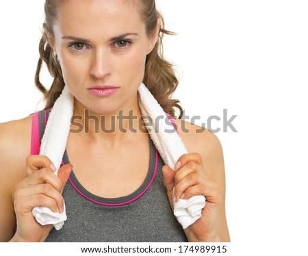 Portrait of serious fitness young woman with towel