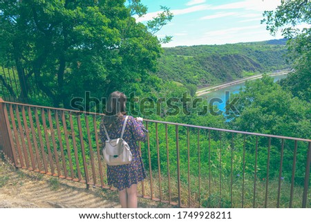 
Summer sunny lifestyle fashion portrait of young stylish hipster woman walking in mountains, wearing cute trendy outfit, smiling enjoy weekends, travel with backpack. awesome water