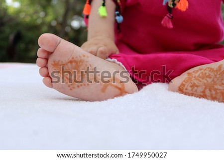 Newborn baby feet on a blurry natural background. Very cute tiny baby on a white blanket.