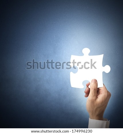 Businessman holding the missing piece of puzzle