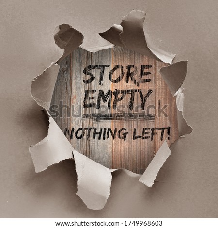Text "Store empty nothing left" painted black on wooden boards through the hole in wrapping craft paper. Boutique shops, stores boarded up against violence. Aftermath, riots, looting in New York City.