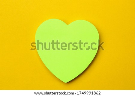 Blank sticker in the shape of a heart with copyspace for writing text or lettering. Background