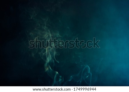 smoke on blackbackground.Movement of white smoke.black background. Smoke from cigarettes.  Royalty-Free Stock Photo #1749996944