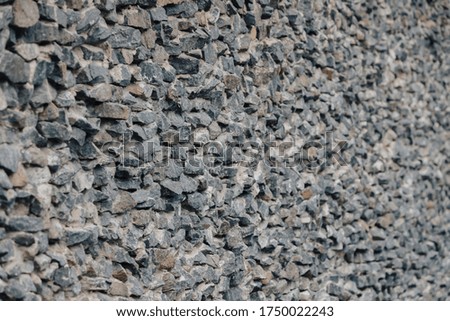 Stone wall. Detailed texture of a wall lined with cobblestones with cement.