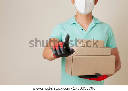 Delivery man holding parcel boxes and ring the doorbell on the client's door in the wall background.