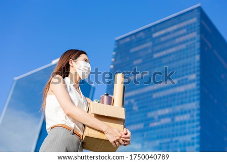 Asian business woman wear face mask and she is being fired because of economic downturn due to covid-19 spread all over the world