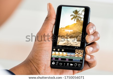 Editing Videos On Mobile Phone Using Video Editor App Royalty-Free Stock Photo #1750056071
