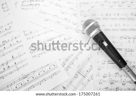 dynamic microphone on music sheet Royalty-Free Stock Photo #175007261