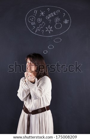 Furious woman next to a chalkboard showing her emotions