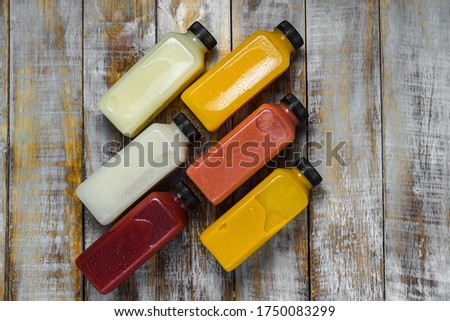 Bottled cold-pressed juice on the wooden table Royalty-Free Stock Photo #1750083299