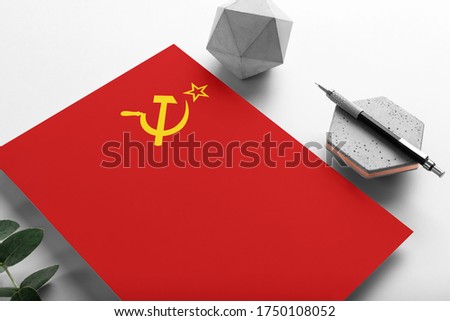 Soviet Union flag on minimalist paper background. National invitation letter with stylish pen on stone. Communication concept.