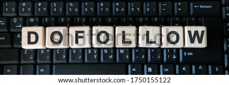 Dofollow web link - business concept text on wooden cubes on background black keyboard