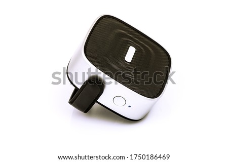 Black small portable speaker with grey, silver insert parts, holder, handle and buttons isolated on white background