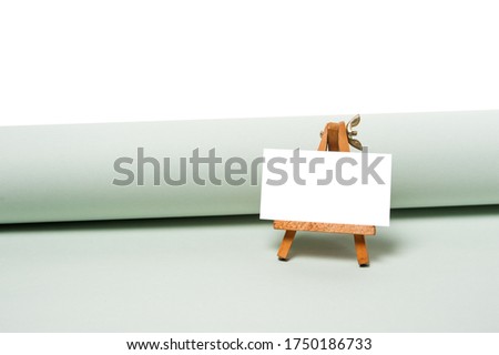 Small easel with empty white card on. for mockup. stand with an empty sheet of paper
