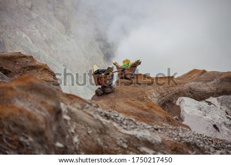 People mining sulphur in Ijen volcano, Java , Indonesia 