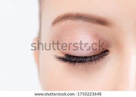 Macro photo woman with long lashes in beauty salon. Concept eyelash extension procedure.