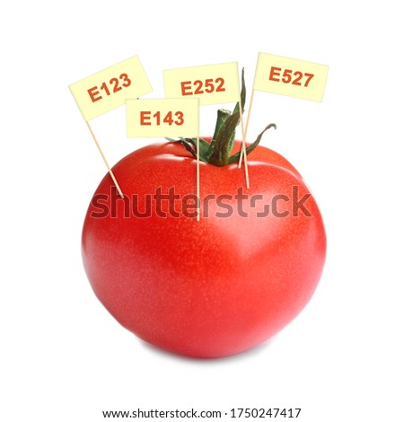 Fresh tomato with E numbers isolated on white. Harmful food additives 