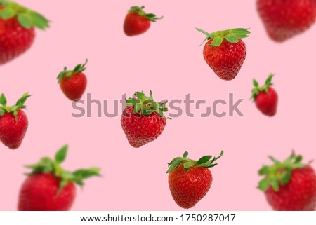 Colorful pattern of falling strawberries on pastel pink background, strawberry background Royalty-Free Stock Photo #1750287047