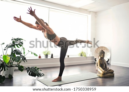 A Nice yoga teacher woman in a studio indoors