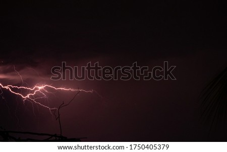 Lightning storm over the city buildings. Lightning bolt strike during a thunderstorm on metropolitan city. Dark sky with bright electrical flash, thunder and thunderbolt, bad weather concept