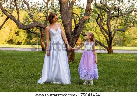Bride with a child walks in the park
