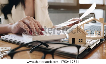 agents working in real estate investment and home insurance signing contracts in accordance with home buying insurance agreements approving purchases for clients.
