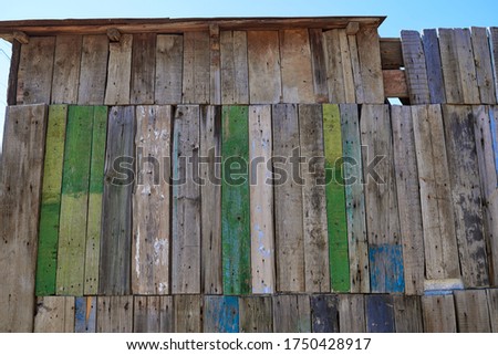 Retro vintage background from multi-colored wooden boards. Rustic old house