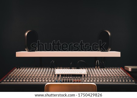 audio mixing console and monitor loudspeakers in sound studio. recording,  broadcasting and post production concept