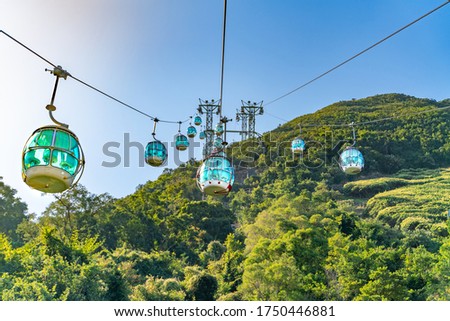 The sunny view of cable car and theme park near to ocean