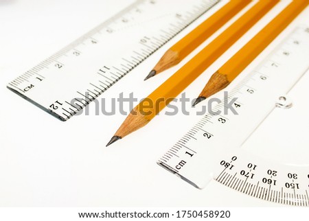 Ruler, protractor and pencils on a white background, drawing, stationery.