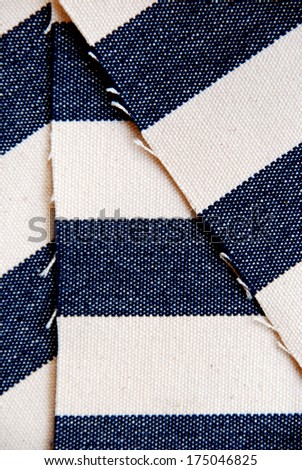 Lapped navy blue striped canvas closeup.
