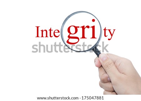 Hand Showing Integrity Word Through Magnifying Glass 