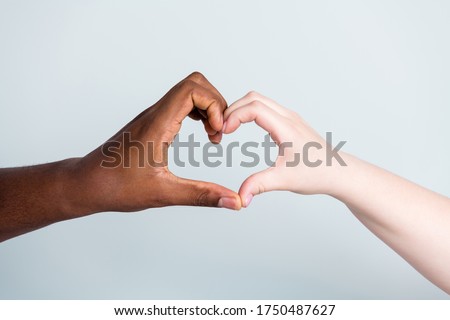 Closeup photo of two hands arms different race skin color multinational couple best friends anti racism issue help together showing heart figure love save world isolated grey background Royalty-Free Stock Photo #1750487627