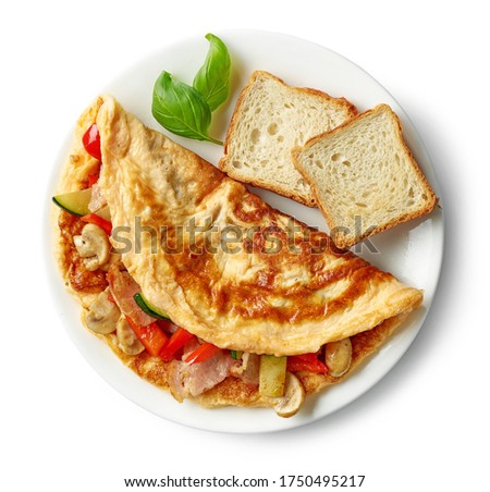 omelette stuffed with vegetables and bacon on white plate isolated on white background, top view Royalty-Free Stock Photo #1750495217