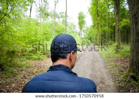 A man in a cap in the woods