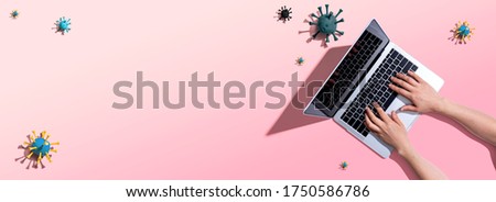 Laptop computer with epidemic influenza concept - overhead view